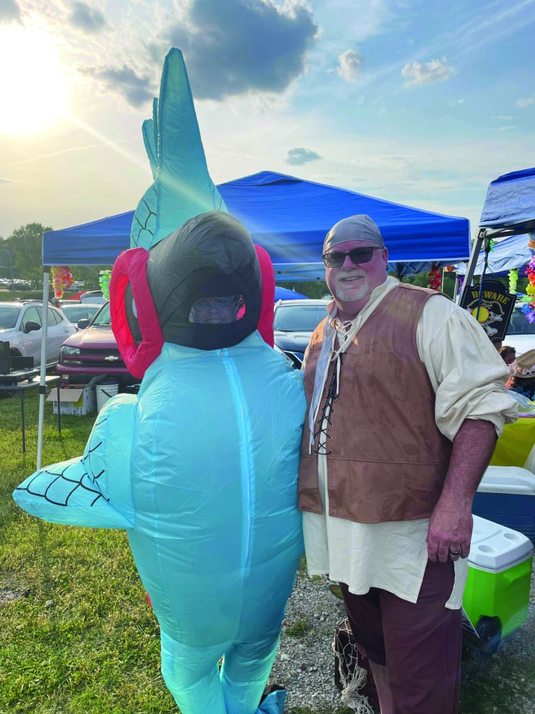 Melanie Russell McLary, left, is joined by her husband, Darrin, at one of Jimmy Buffett's shows. The singer-songwriter died Friday at age 76. (Contributed)